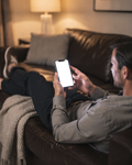 iPhone Mockup — People Couch Man Lounge — Transparent Screen PNG Download | Commercial Licence | bulkmockup