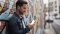 iPhone Mockup — People Street Man Leaning — High-Res PNG with Transparent Screen | Commercial Use | bulkmockup | MockupBulk